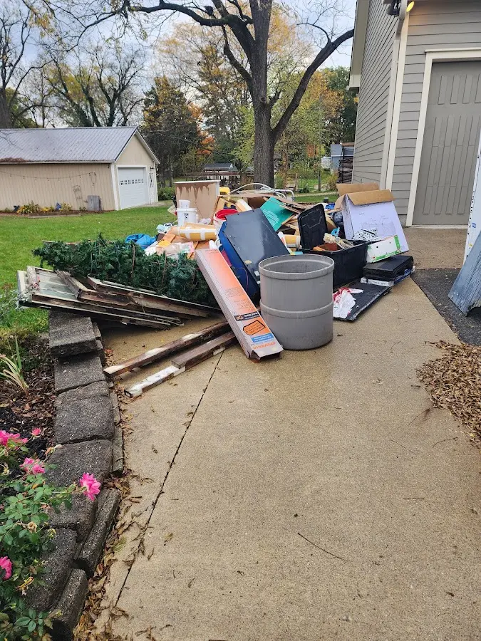 Dumpster being loaded with debris for 12 Yard Dumpster Rental in Park Rapids